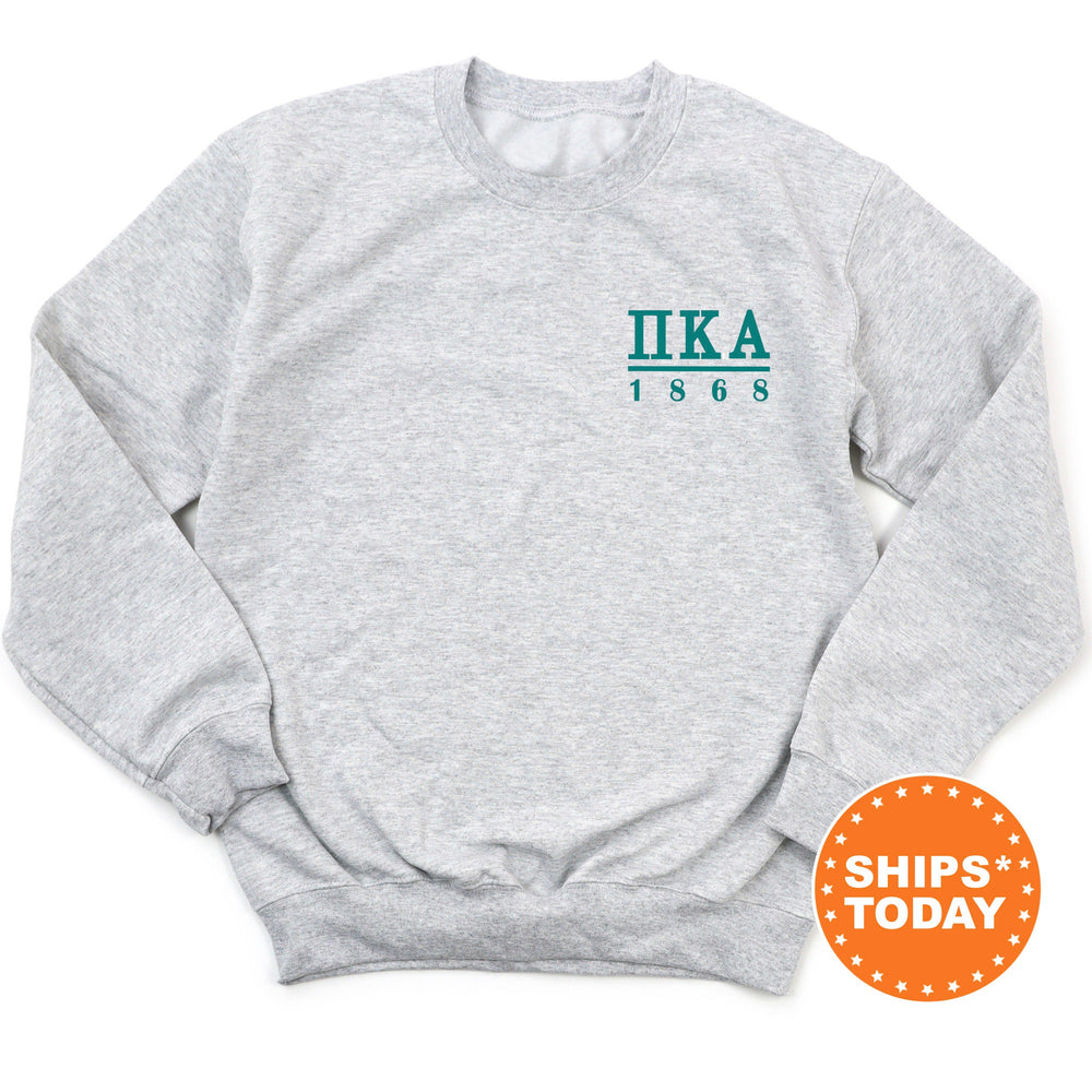 a gray sweatshirt with a green logo on it