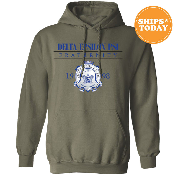 a green sweatshirt with a blue and white crest on it