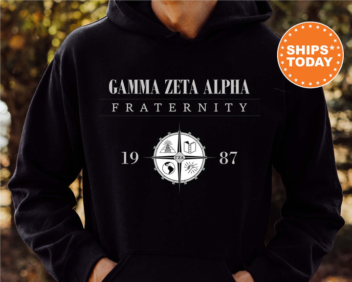a person wearing a black hoodie with a cross on it