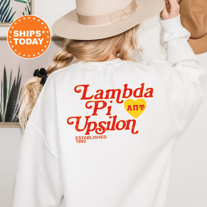 a woman wearing a white sweatshirt and a hat