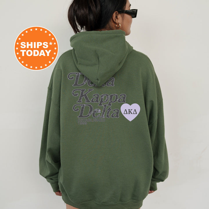 a woman wearing a green hoodie with a heart on it