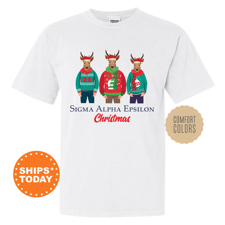 a white t - shirt with three reindeers wearing ugly sweaters
