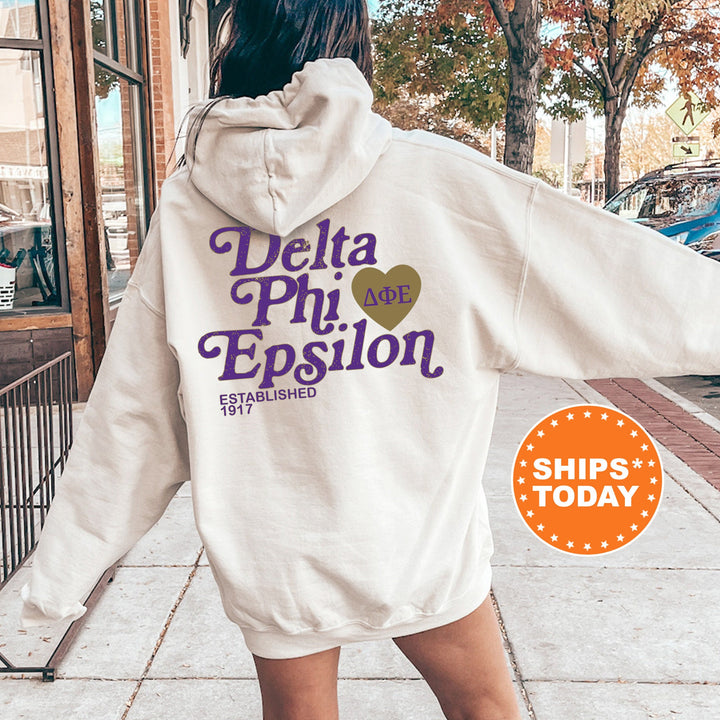 a woman walking down a sidewalk wearing a white hoodie