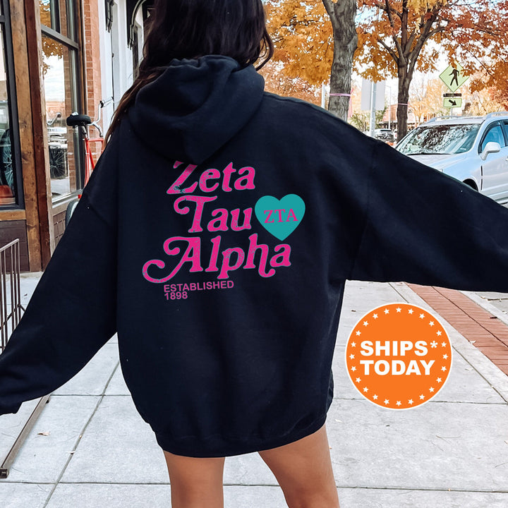 a woman in a black hoodie is walking down the street