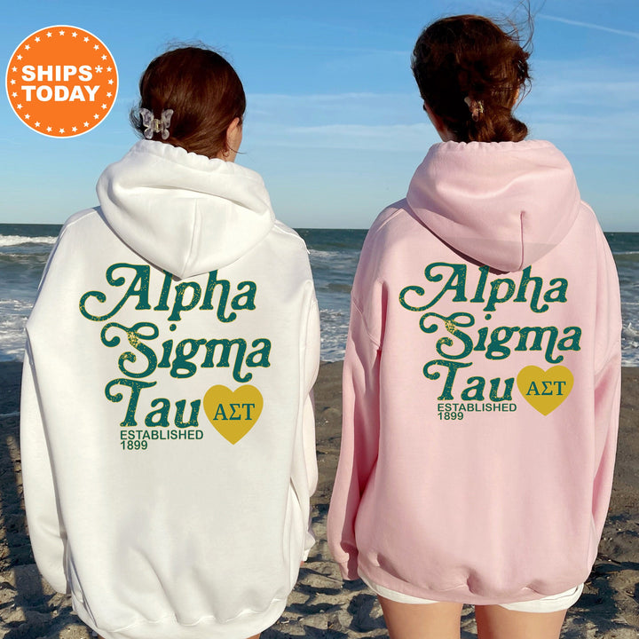 two women wearing matching sweatshirts on the beach