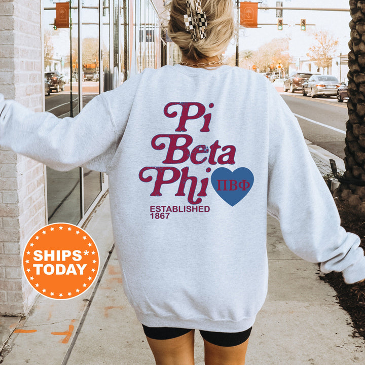 a woman walking down a sidewalk wearing a sweatshirt