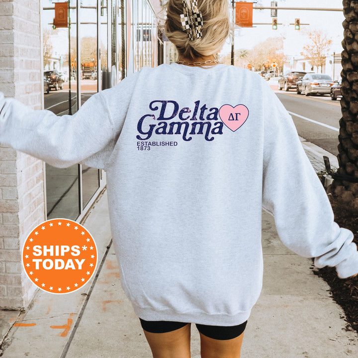 a woman walking down a sidewalk wearing a sweatshirt