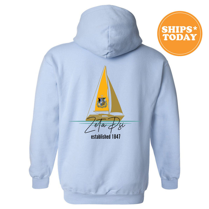 a light blue hoodie with a sailboat on it