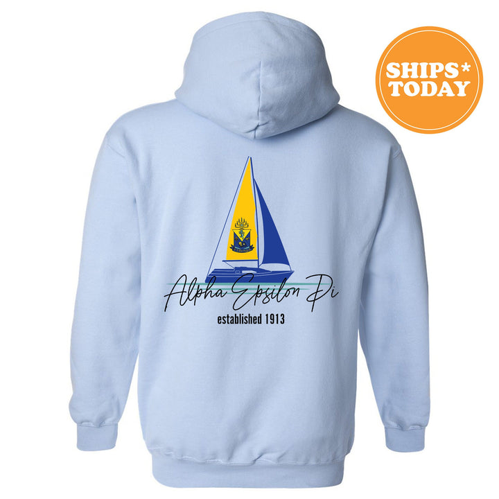 a light blue hoodie with a sailboat on it