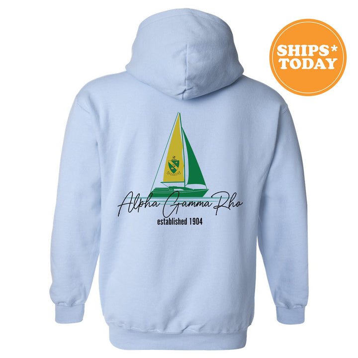 a light blue hoodie with a sailboat on it