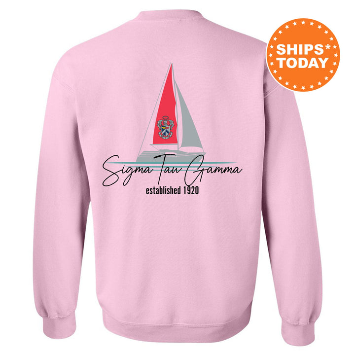 a pink sweatshirt with a sailboat on it