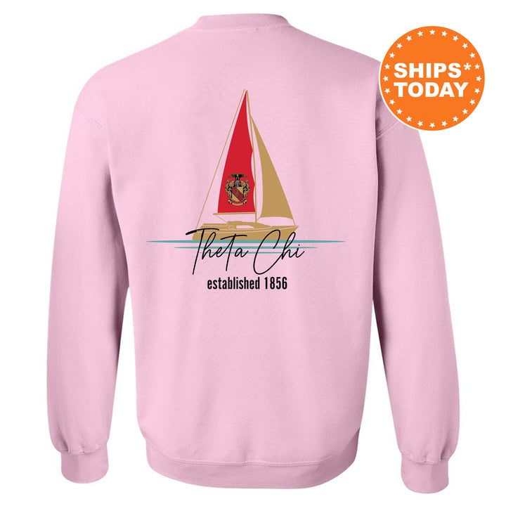 a pink sweatshirt with a sailboat on it