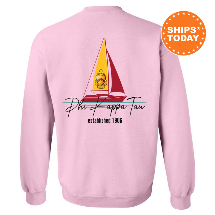 a pink sweatshirt with a sailboat on it