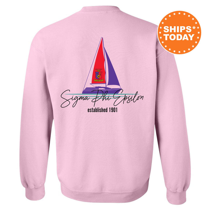 a pink sweatshirt with a sailboat on it