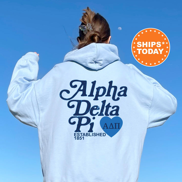 a woman wearing a white hoodie with a blue heart on it