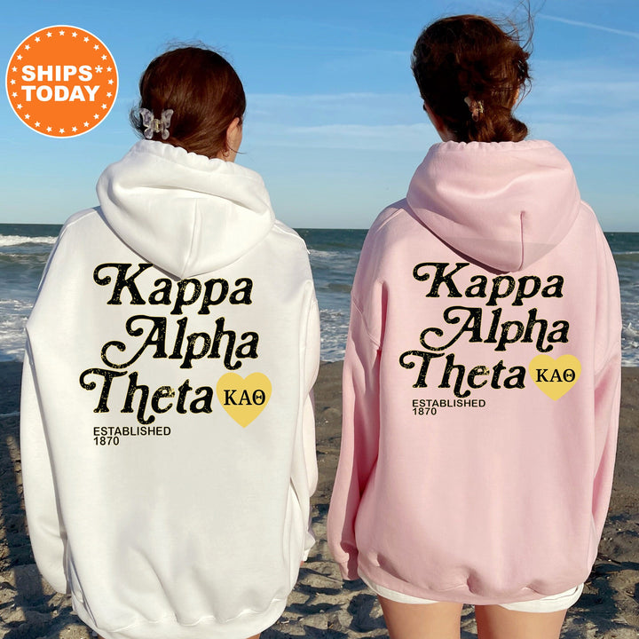 two women wearing matching sweatshirts on the beach
