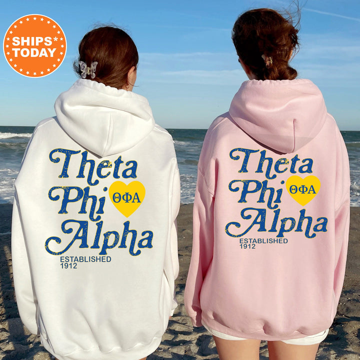 two girls wearing matching sweatshirts on the beach