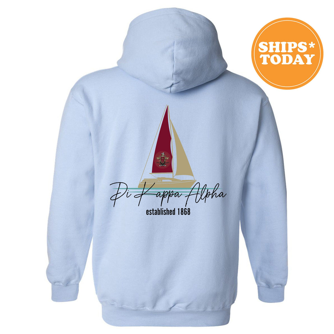 a white hoodie with a red sailboat on it