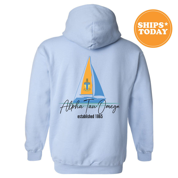 a light blue hoodie with a sailboat on it