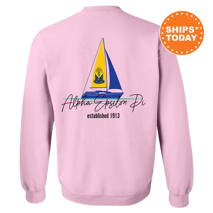 a pink sweatshirt with a sailboat on it