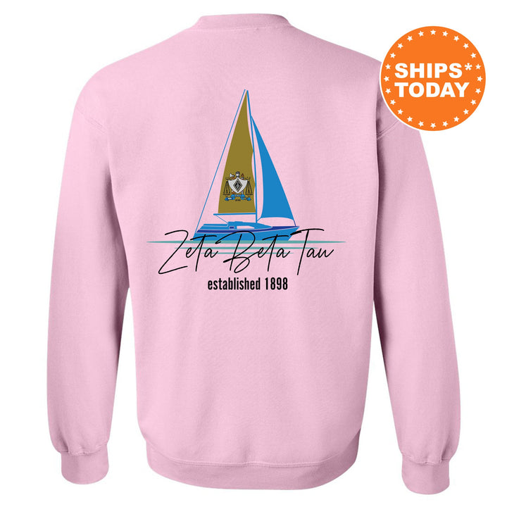 a pink sweatshirt with a sailboat on it