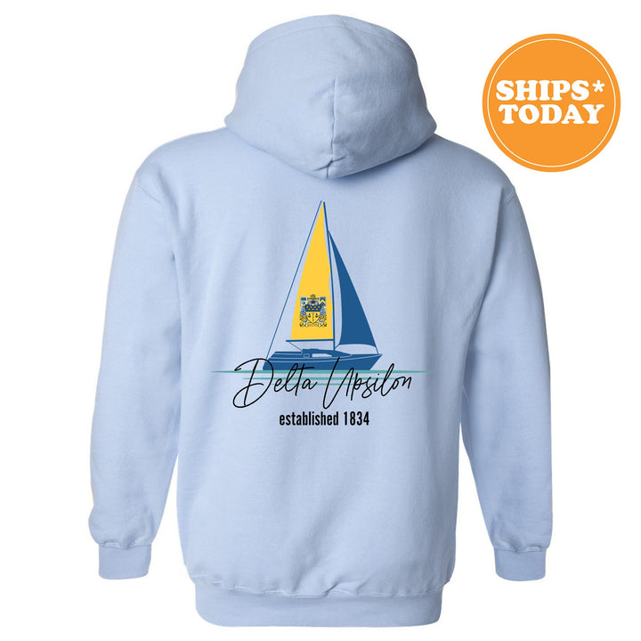 a light blue hoodie with a sailboat on it