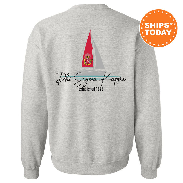 a grey sweatshirt with a red sailboat on it