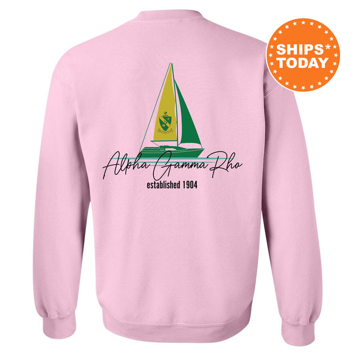 a pink sweatshirt with a sailboat on it