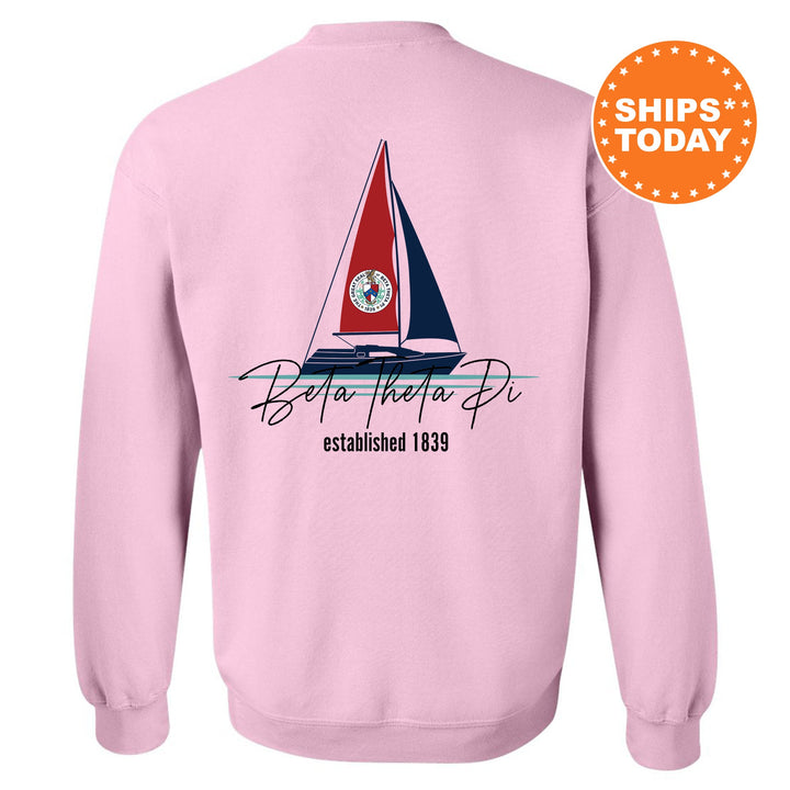 a pink sweatshirt with a sailboat on it