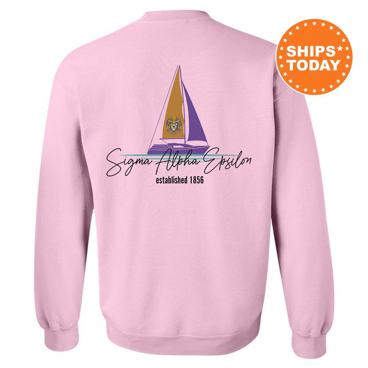 a pink sweatshirt with a sailboat on it