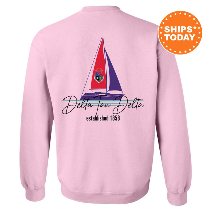 a pink sweatshirt with a sailboat on it