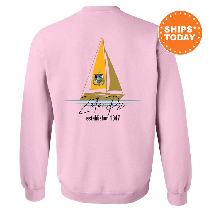 a pink sweatshirt with a sailboat on it