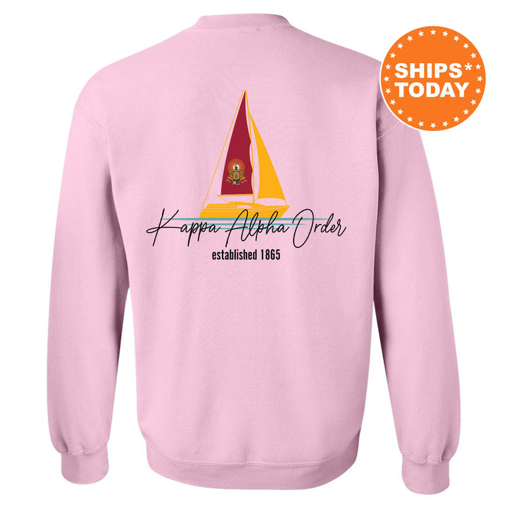 a pink sweatshirt with a sailboat on it