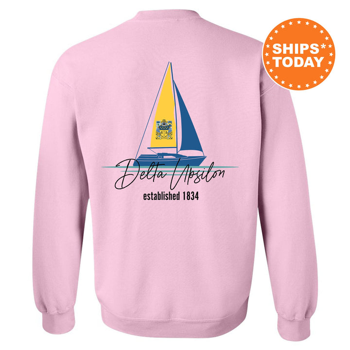 a pink sweatshirt with a sailboat on it