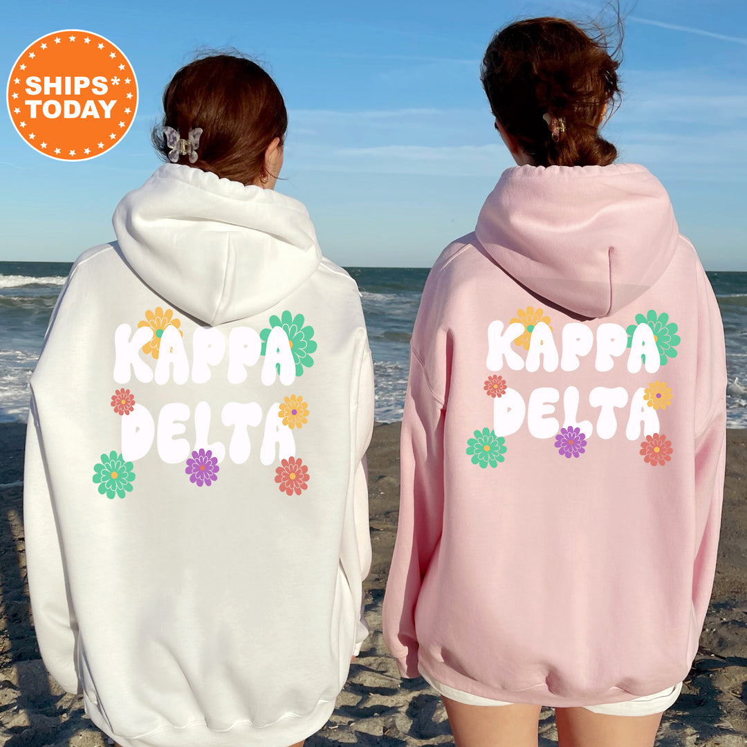 two women wearing matching sweatshirts on the beach