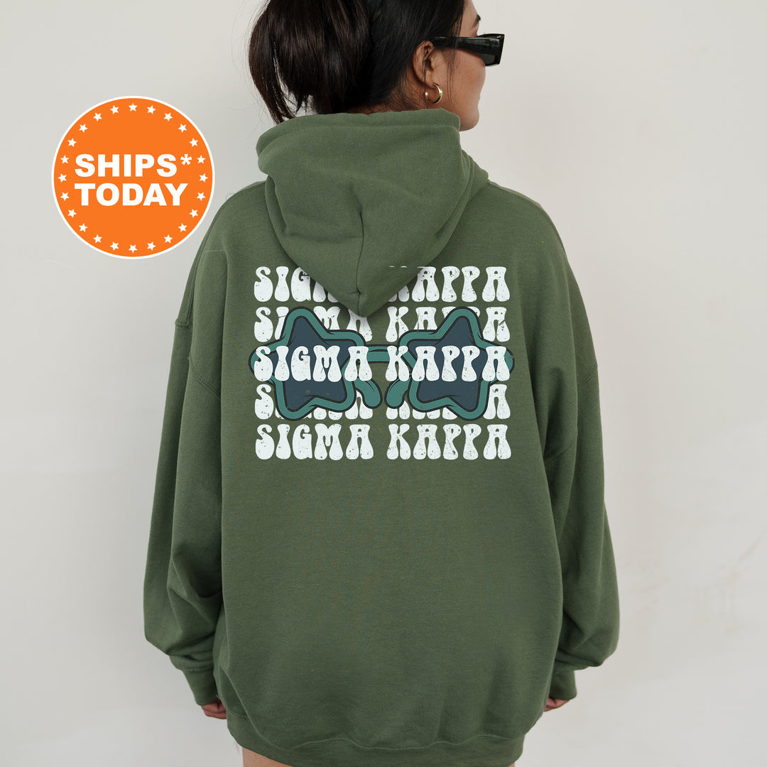 a woman wearing a green hoodie with an image of a shark on it