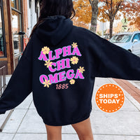 A person wearing a black hoodie with the text 