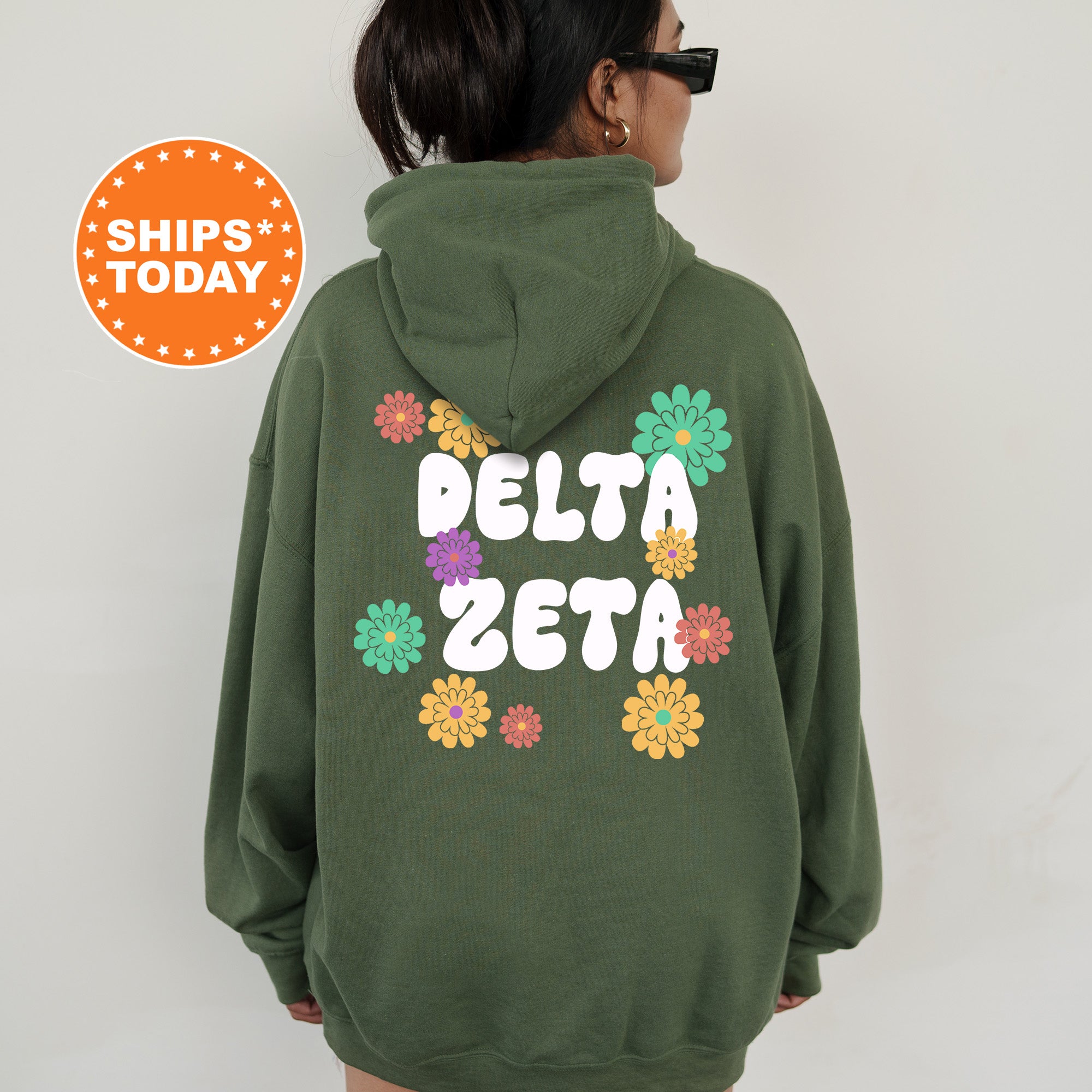 a woman wearing a green hoodie that says delta zeta