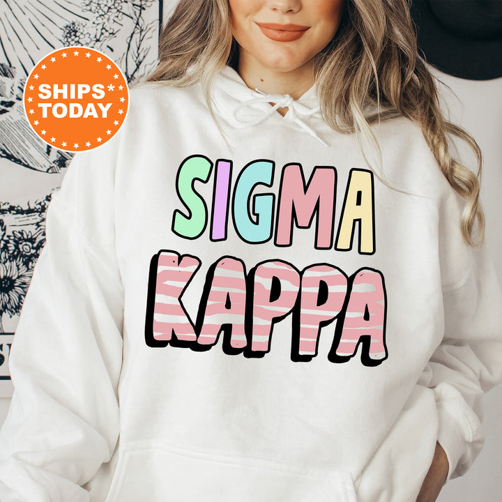 a woman wearing a white sweatshirt that says stigma kappa