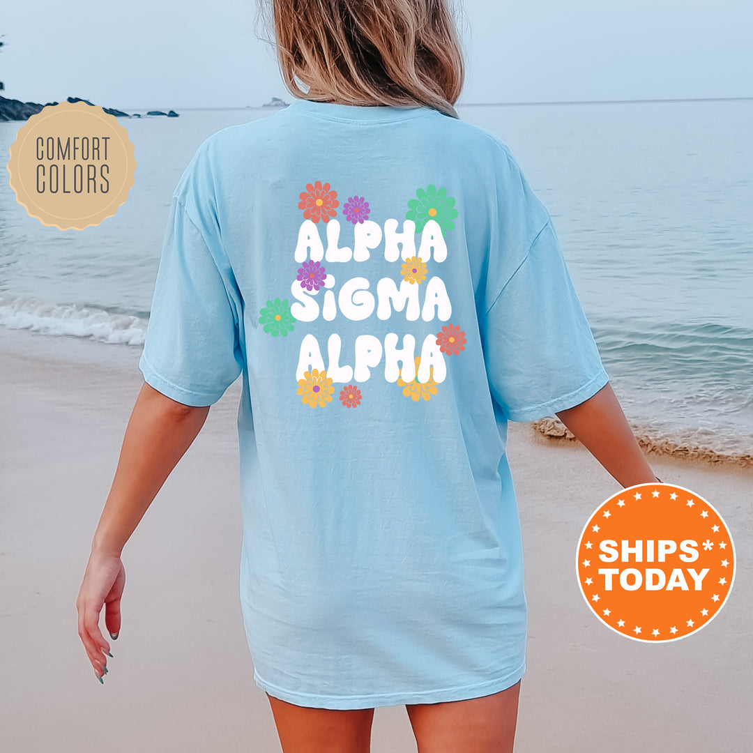 a woman walking on the beach wearing a blue shirt