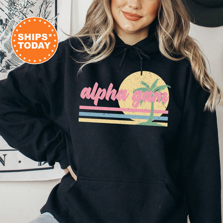 a woman wearing a black hoodie with a palm tree on it