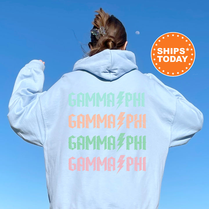 a woman wearing a white hoodie with rainbow writing on it
