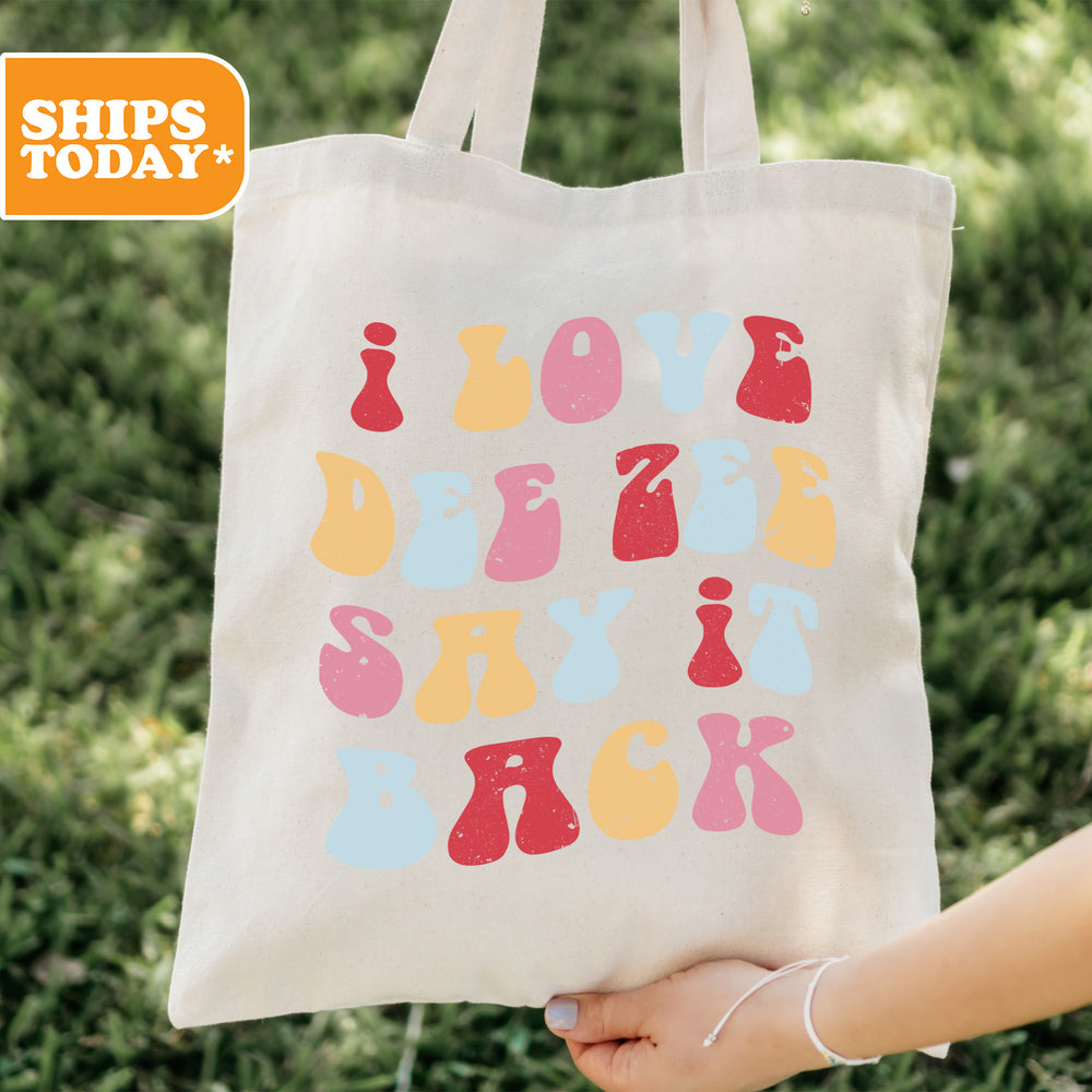 a person holding a tote bag with a design on it