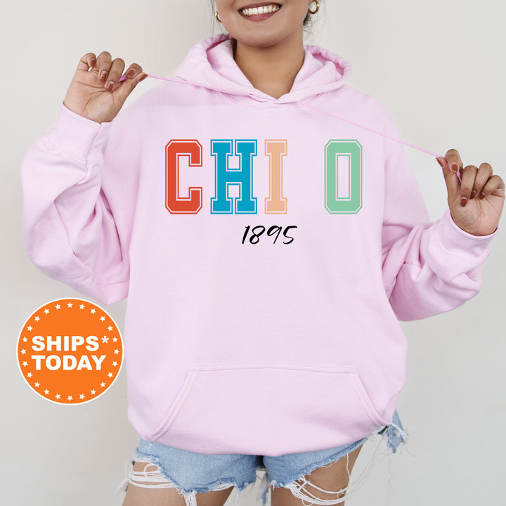 a woman wearing a pink hoodie with the word chicago printed on it