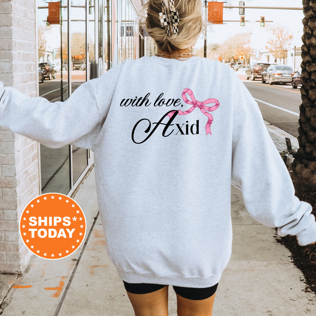 a woman walking down a sidewalk wearing a sweatshirt