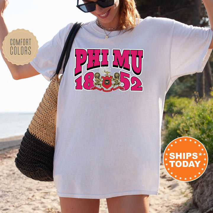 a woman wearing a white shirt with pink letters on it