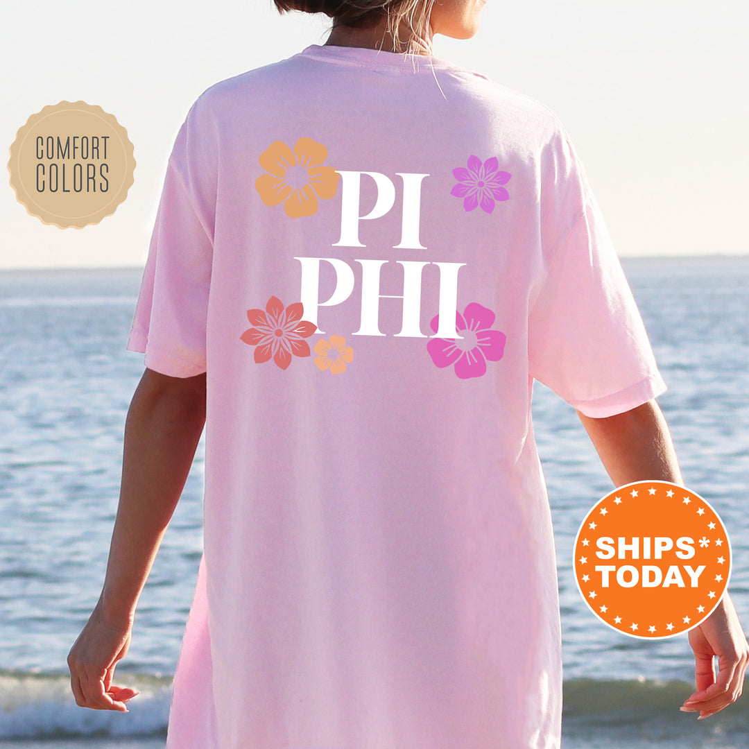 a woman standing on a beach wearing a pink shirt