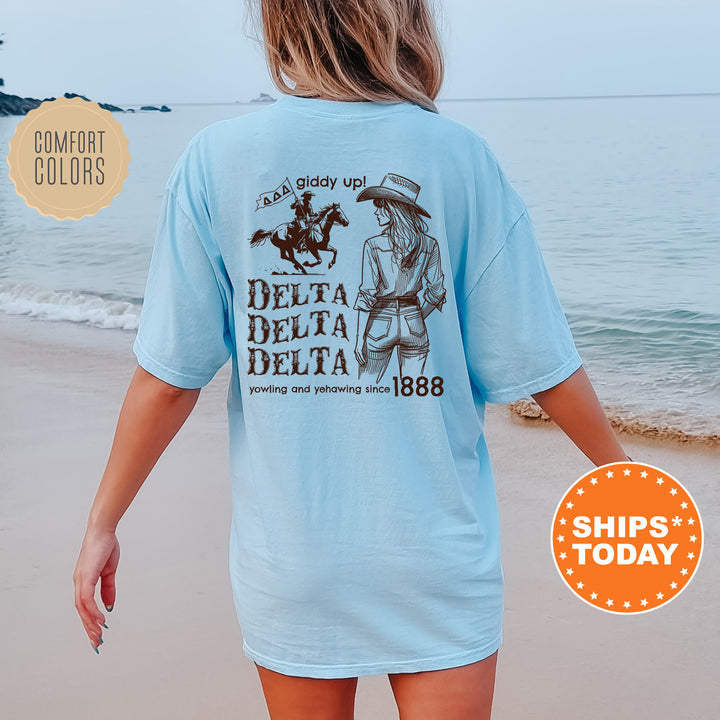 a woman walking on the beach wearing a blue delta delta shirt