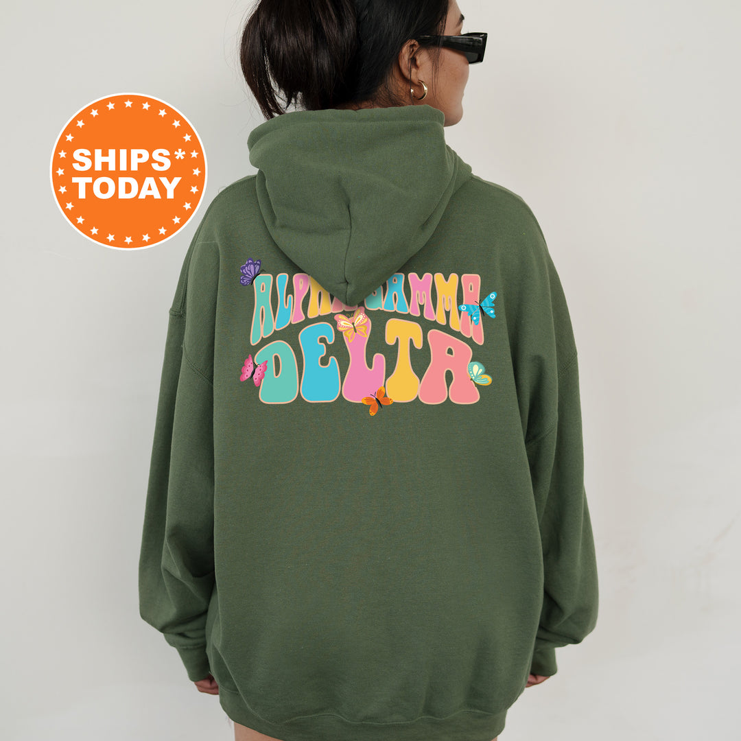 a woman wearing a green hoodie with a back print