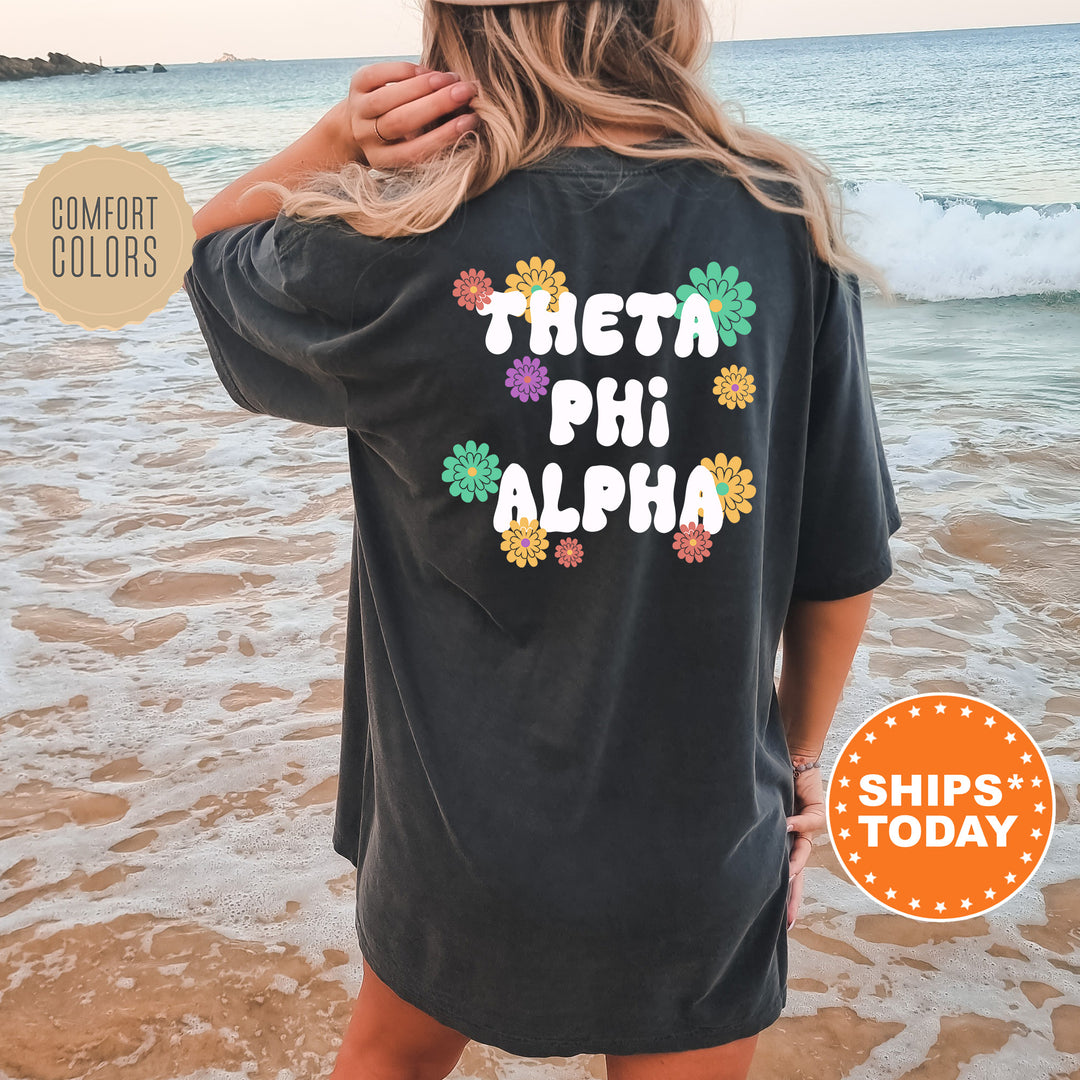 a woman standing on a beach wearing a black shirt